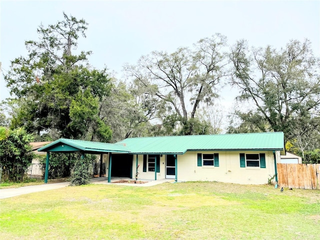 ranch-style house with a carport and a front yard