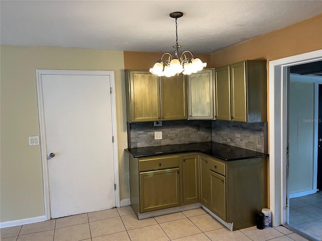 kitchen with hanging light fixtures, decorative backsplash, light tile patterned floors, and a chandelier