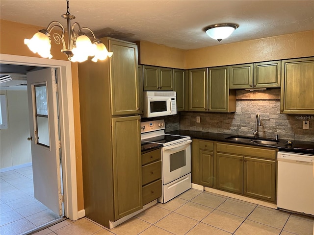 kitchen featuring light tile patterned flooring, decorative light fixtures, sink, decorative backsplash, and white appliances