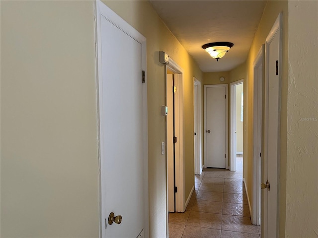 corridor featuring light tile patterned floors