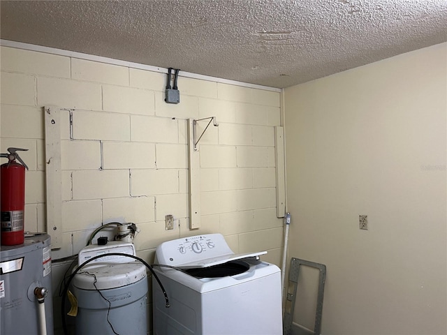 laundry room featuring washer / clothes dryer, water heater, and a textured ceiling