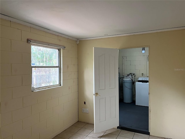 interior space featuring washer / dryer and light tile patterned floors