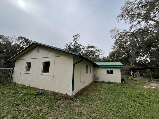 view of property exterior with a lawn