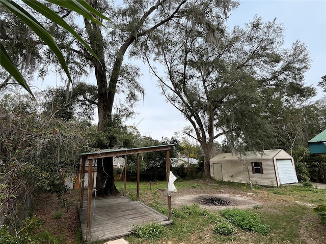 view of yard with a garage and an outbuilding