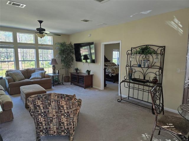 living room featuring light carpet and ceiling fan