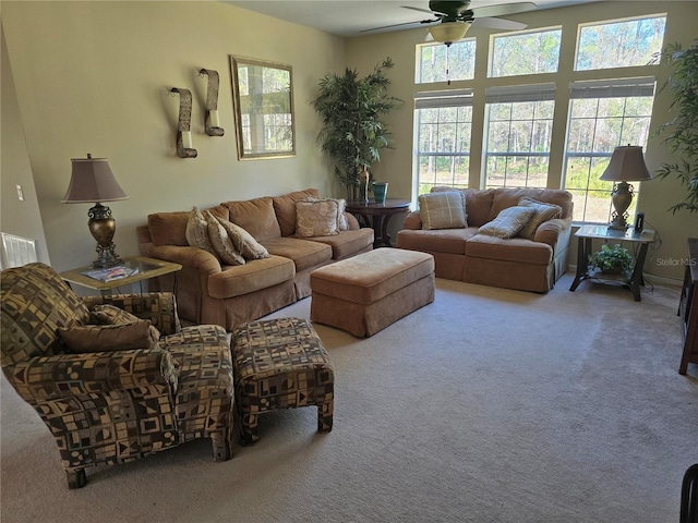 living room with ceiling fan and carpet