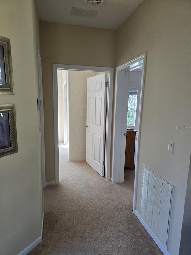 hall with light colored carpet