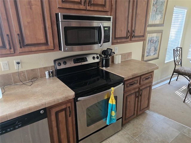 kitchen with appliances with stainless steel finishes and light tile patterned floors