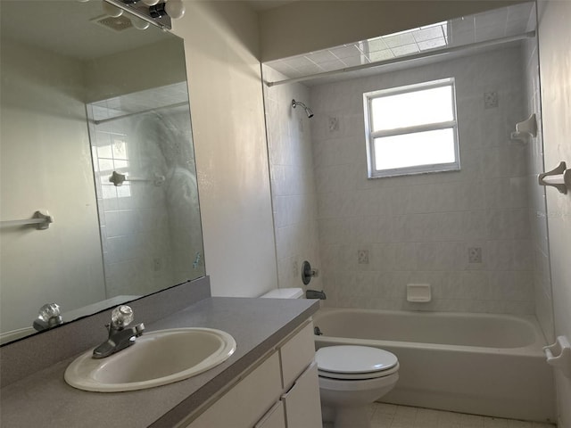 full bathroom featuring toilet, vanity, and tiled shower / bath