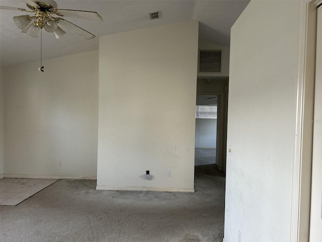 carpeted spare room featuring ceiling fan