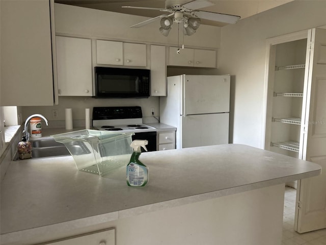 kitchen with sink, white cabinets, electric stove, and white fridge