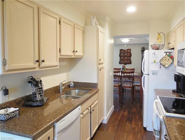 kitchen with dark hardwood / wood-style floors, sink, white appliances, and dark stone counters