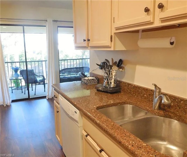 kitchen with white cabinetry, white dishwasher, sink, and dark stone countertops