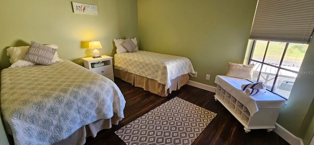 bedroom with dark hardwood / wood-style floors