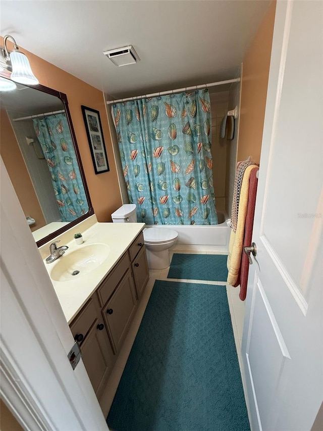 full bathroom featuring shower / tub combo with curtain, vanity, toilet, and tile patterned flooring