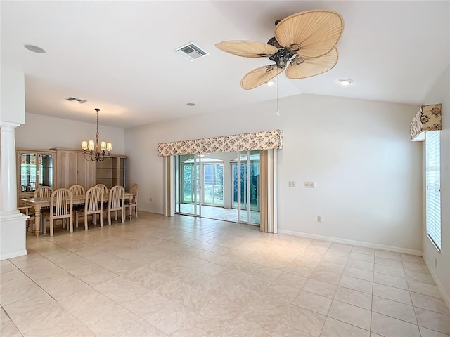 spare room featuring ceiling fan with notable chandelier, light tile patterned floors, decorative columns, and vaulted ceiling