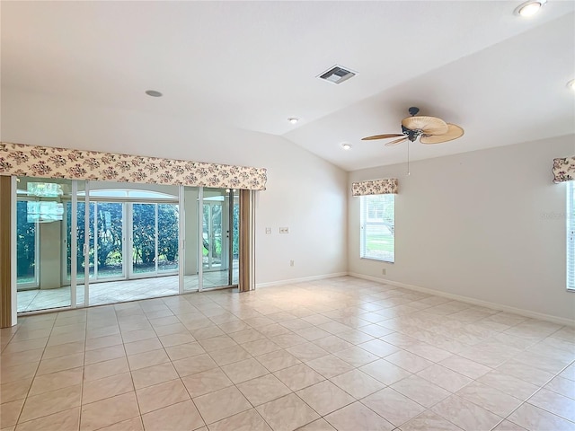 spare room featuring ceiling fan, light tile patterned flooring, and lofted ceiling