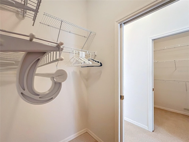 spacious closet featuring light carpet