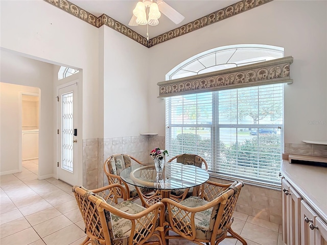 tiled dining space featuring ceiling fan and a healthy amount of sunlight