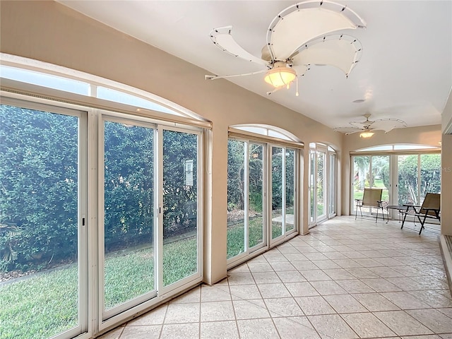 unfurnished sunroom featuring ceiling fan