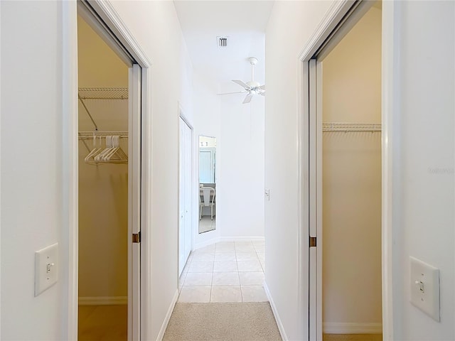 hallway featuring light colored carpet