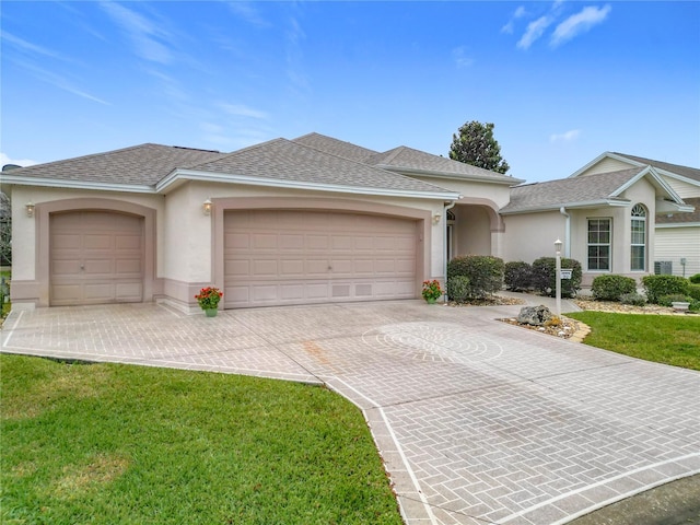 single story home with a front lawn and a garage