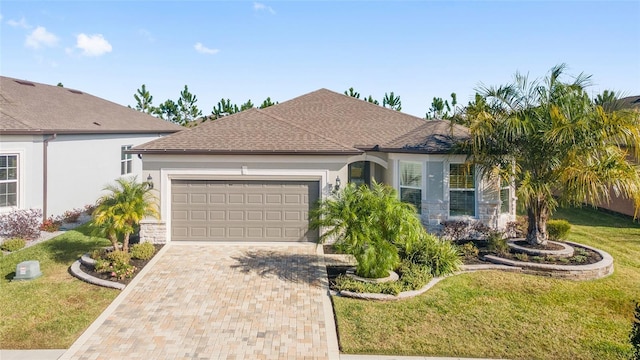 ranch-style home featuring a front lawn and a garage