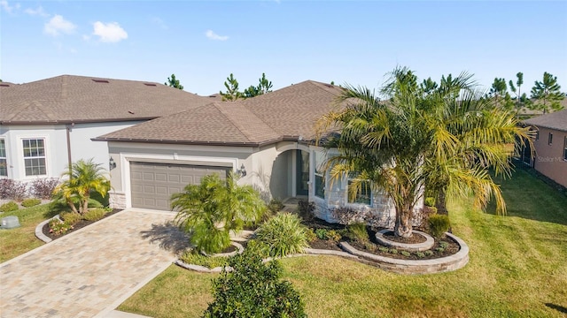 view of front of home featuring a garage and a front lawn