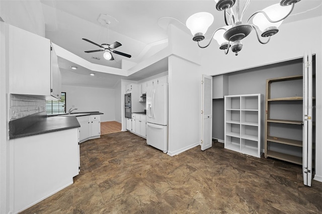 kitchen featuring ceiling fan with notable chandelier, sink, white cabinets, and white refrigerator with ice dispenser