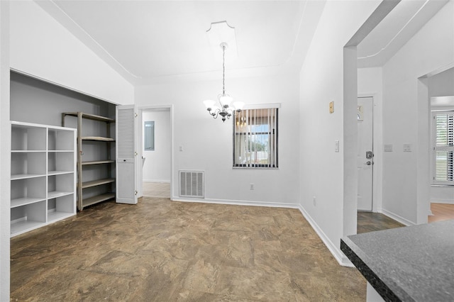 unfurnished dining area with a notable chandelier