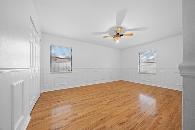 spare room with ceiling fan, plenty of natural light, and light hardwood / wood-style floors