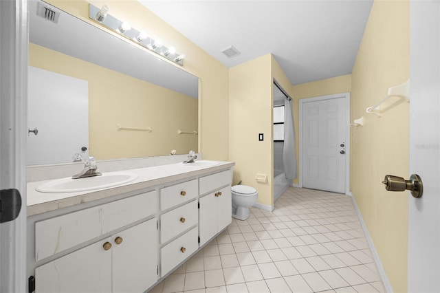 bathroom featuring tile patterned floors, vanity, and toilet