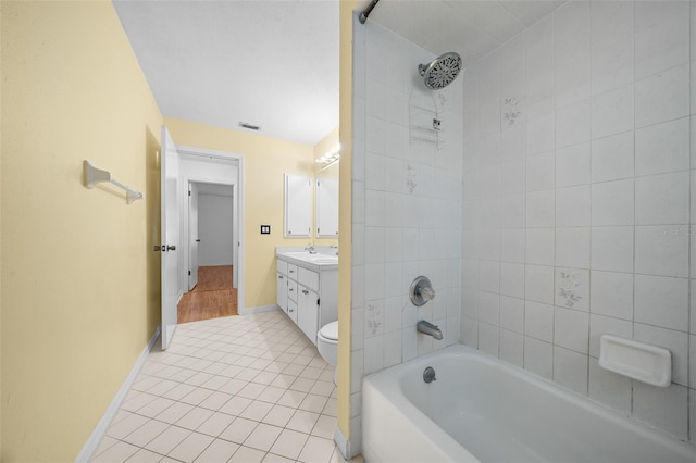 full bathroom featuring tile patterned floors, vanity, toilet, and tiled shower / bath