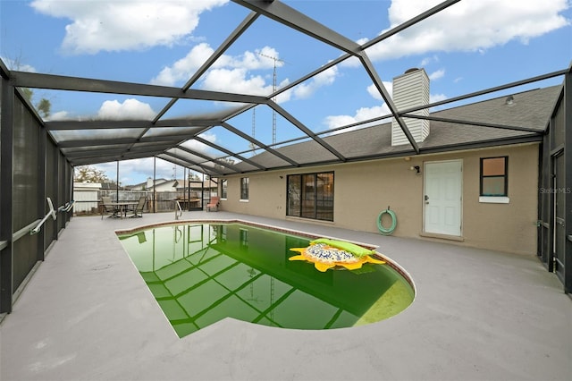 view of swimming pool featuring a lanai and a patio area