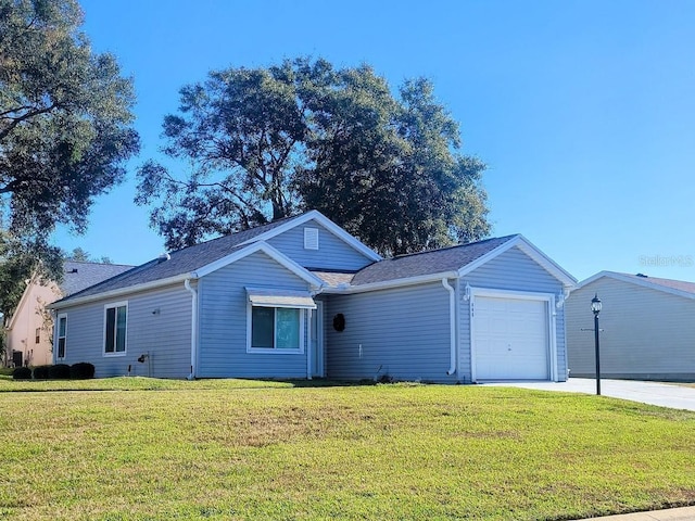 ranch-style house featuring a front yard and a garage