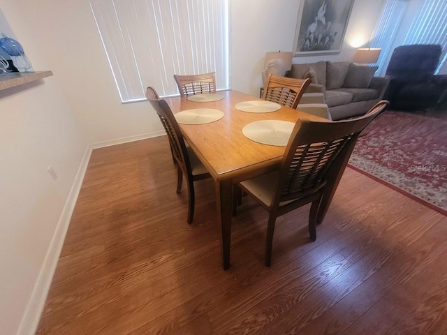 dining room with dark wood-type flooring