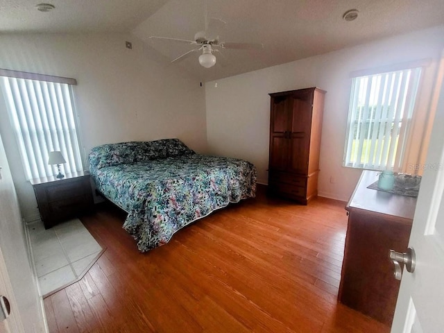 bedroom featuring vaulted ceiling, ceiling fan, and hardwood / wood-style flooring