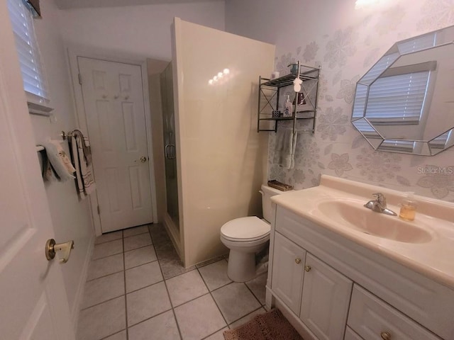 bathroom with toilet, an enclosed shower, tile patterned flooring, and vanity