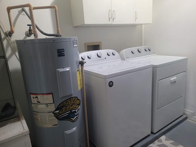 clothes washing area with water heater, cabinets, and washing machine and clothes dryer