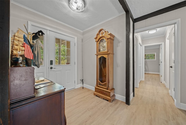 mudroom featuring a textured ceiling, ornamental molding, and light hardwood / wood-style floors