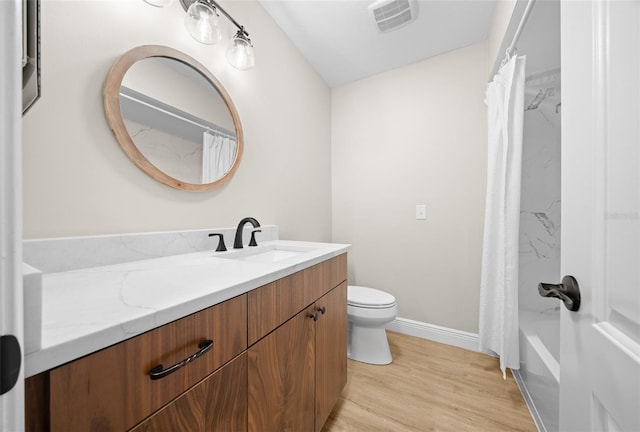 full bathroom with toilet, shower / bath combo, hardwood / wood-style floors, and vanity