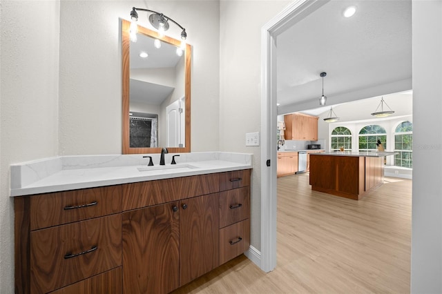 bathroom featuring vanity, vaulted ceiling, and hardwood / wood-style flooring