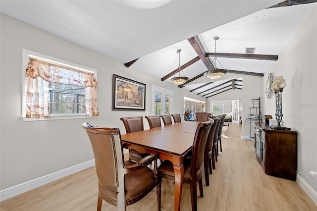 dining room featuring light hardwood / wood-style flooring and lofted ceiling with beams