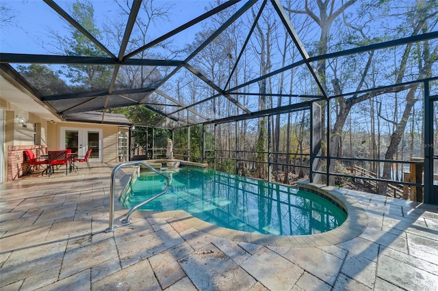 view of pool with a lanai, french doors, and a patio