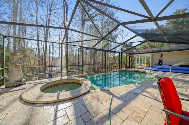 view of swimming pool featuring an in ground hot tub, a lanai, and a patio