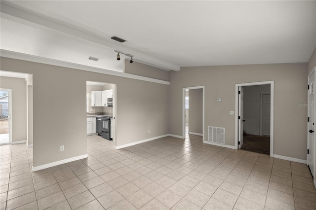 unfurnished living room with lofted ceiling and light tile patterned flooring