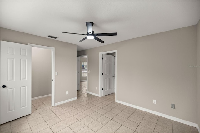 unfurnished bedroom featuring light tile patterned flooring, ceiling fan, and a closet