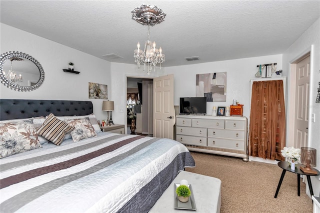 bedroom featuring a notable chandelier, a textured ceiling, and carpet flooring