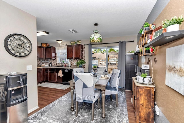 dining space featuring a textured ceiling and dark hardwood / wood-style floors