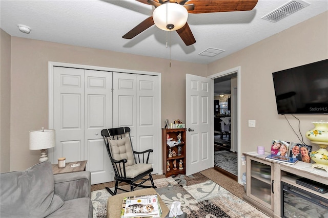 carpeted living room featuring ceiling fan